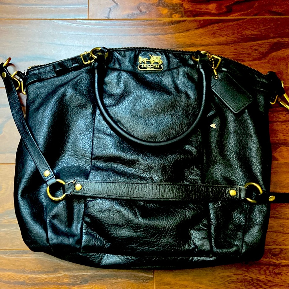 Used black Coach shoulder bag with purple lining.